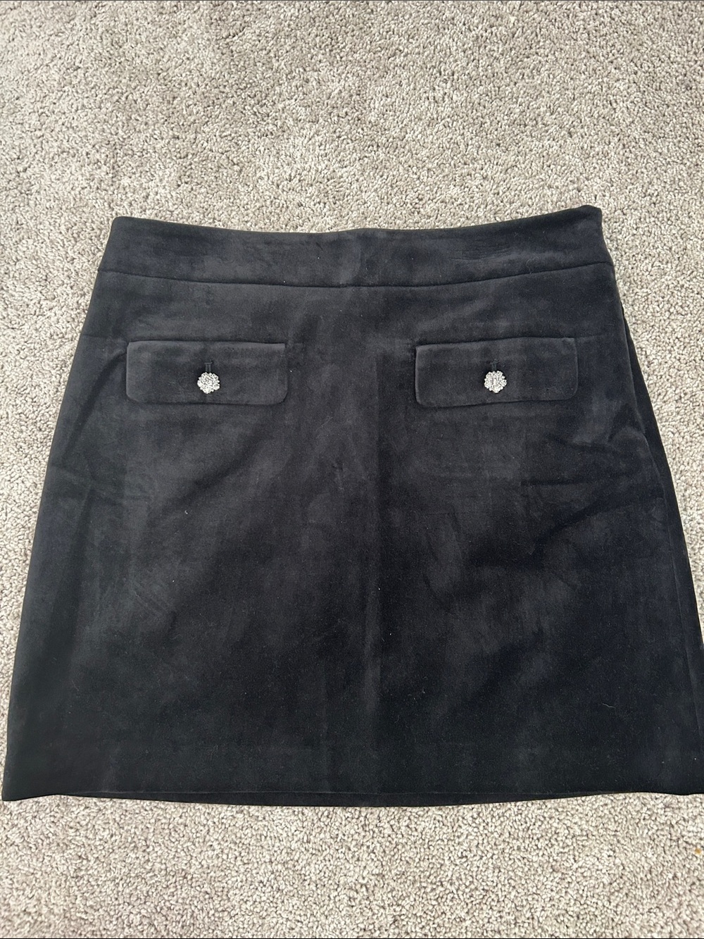 Black velvet Mini Skirt with Decorative Buttons on welt front pockets.